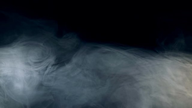 Puffs of mist are dissolving in darkness