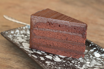 Close up of Chocolate cake sliced on wooden desk
