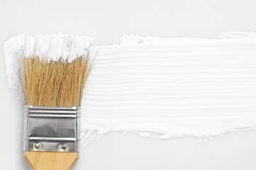 White paint stroke and brush