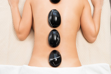 Obraz na płótnie Canvas Chakra Balancing massage scrub hot stone
