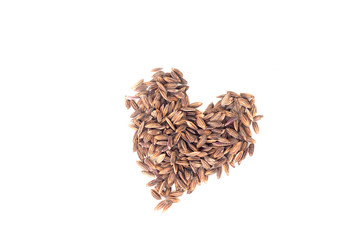 Pile of brown rice in heart shape isolated on white background