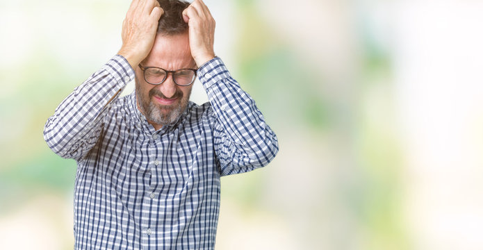 Handsome middle age elegant senior business man wearing glasses over isolated background suffering from headache desperate and stressed because pain and migraine. Hands on head.