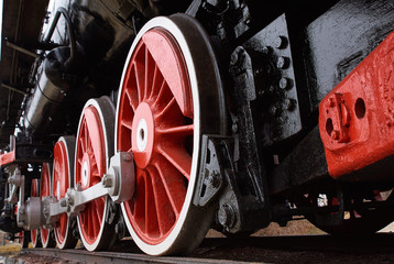 red and white wheels of the old classic steam locomotive, close up view