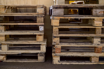 in a warehouse lie in a row of wooden pallets