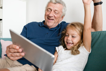 Grandfather playing games with his granddaughter