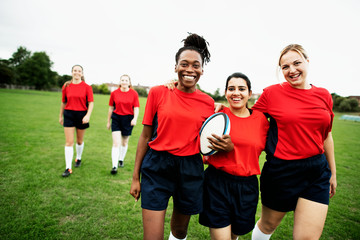 Energetic female rugby players walking together - obrazy, fototapety, plakaty