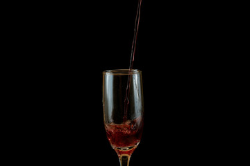 Pouring delicious red wine into glass