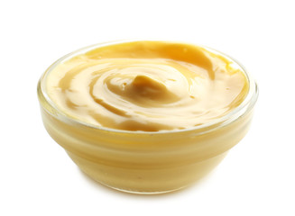 Tasty yellow sauce in bowl on white background