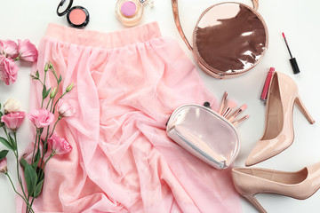 Composition with skirt and female items on white background