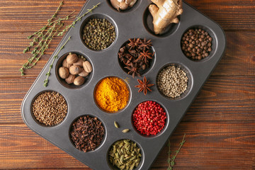 Different aromatic spices in holder on wooden table