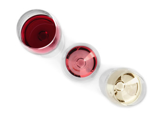 Glasses with different kinds of wine on white background, top view