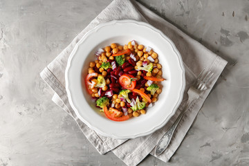 Tasty salad with chickpeas on grey table