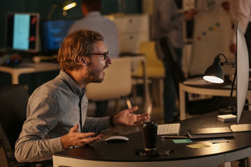 Stressed IT specialist trying to meet deadline in office