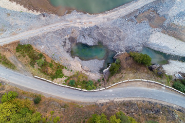 A winding mountain road passes by the lake.