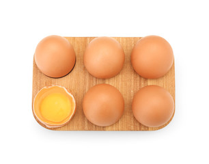 Raw chicken eggs in holder on white background