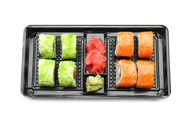 Box with tasty sushi rolls on white background