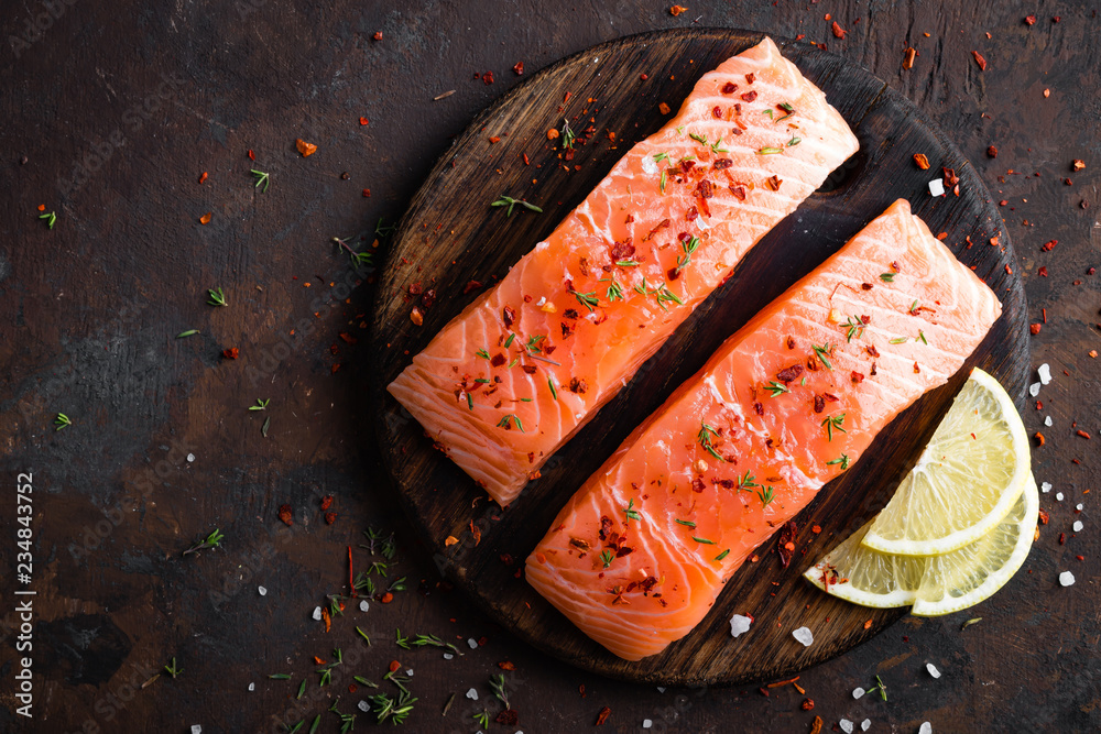 Poster fresh salmon fish fillet on wooden board