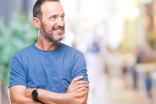 Middle age hoary senior man over isolated background smiling looking side and staring away thinking.