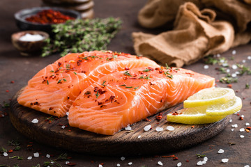 Fresh salmon fish fillet on wooden board - obrazy, fototapety, plakaty