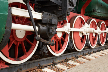 red and white wheels of the old steam locomotive, close up view