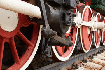 red and white wheels of the old steam locomotive, close up view