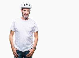 Middle age senior hoary cyclist man wearing bike safety helment isolated background with serious expression on face. Simple and natural looking at the camera.