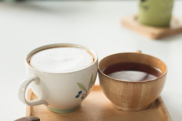 Close up a cup of hot latte coffee on white table