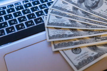 Dollar bills on the laptop