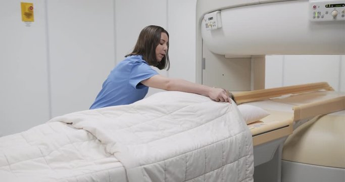 Doctor And Patient In MRI Lab At Medical Center