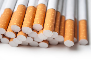 closeup of cigarettes pile on white background