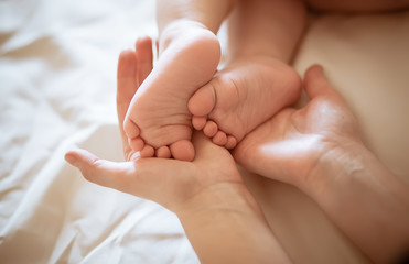 Baby legs in mother's hands