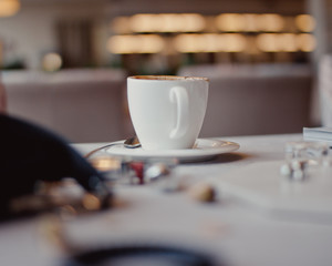 Creative flat lay composition with delicious hot coffee on table in cafe