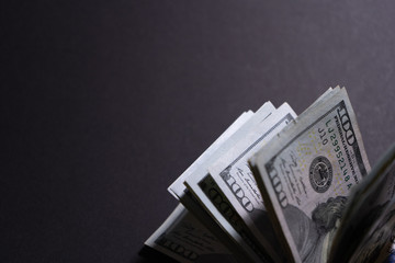Close-up of money in the corner of black background