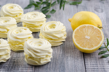 Yellow, apple marshmallow with lemon on wooden vintage background.