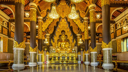 Golden Buddha in a magnificent church   at Wat Prathat Doi Prachan, Lampang Thailand NOV 18 2018
