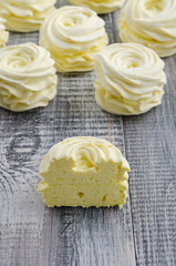 Yellow, apple marshmallow with lemon on wooden vintage background.