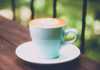 Hot coffee cup on wood table background