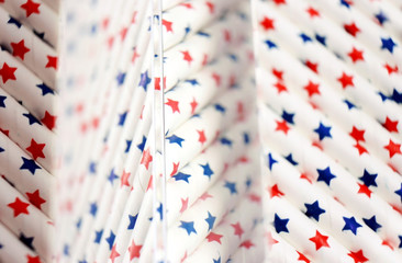 Obraz premium An amazing and beautiful macro with depth of field and space about white straws with blue and red stars that seems like United States flag
