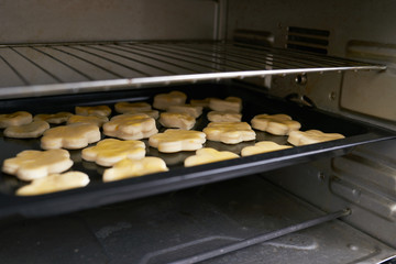 Tray of Christmas cookies baking in oven