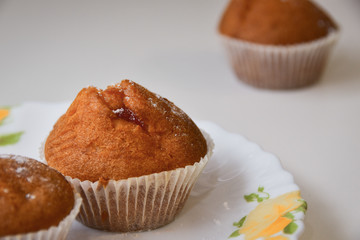 A muffin on a white plate.