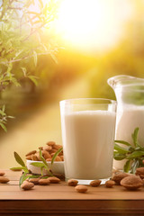 Almond drink on wooden table in the field vertical