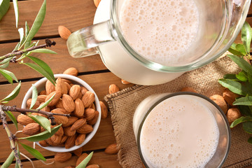 Almond drink on wooden table in the field top view