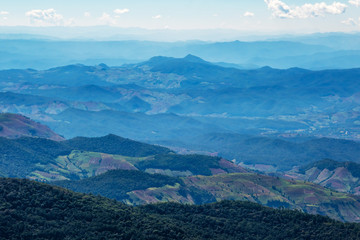 Fototapeta premium The mountains and forests with blue sky and white clouds at the peak of Inthanon national park (park name) in Chiang Mai province , Thailand in a sunny day. 