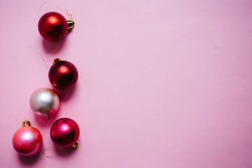Christmas composition. Christmas red and pink decorations on pink background. Flat lay, top view, copy space