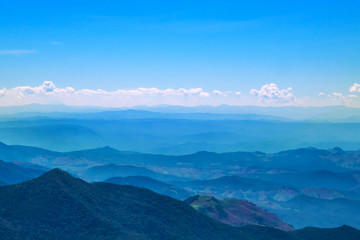Fototapeta na wymiar The mountains and forests with blue sky and white clouds at the peak of Inthanon national park (park name) in Chiang Mai province , Thailand in a sunny day. 