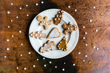 Homemade Christmas gingerbreads on a white plate.