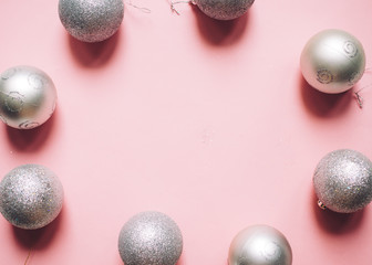 Christmas composition. Christmas silver decoration balls on pink background. Flat lay, top view, copy space