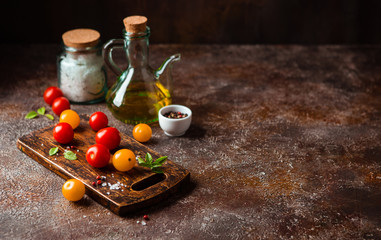Red and yellow fresh tomatos, basil and olive oil