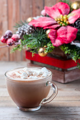 cup of hot cocoa with marshmallows on wooden background