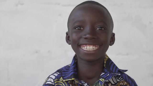 Handsome Boy Smiles on White Background in Slow Motion